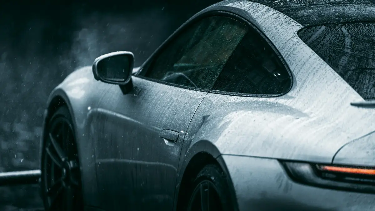 Water beading on the silver paint of a car