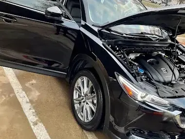 A black vehicle with the hood open